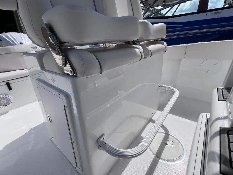 Slide: The Image of 2024 Sea Hunt Ultra 239 SE boat interior with white seating and storage compartment. - 41