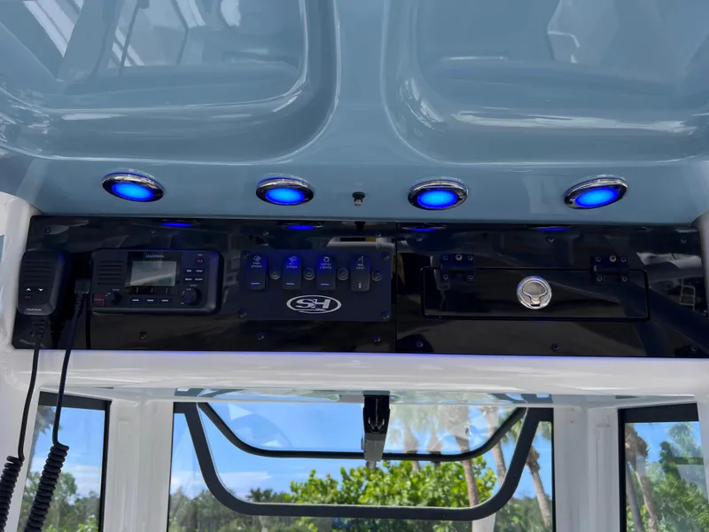 Slide: The Image of 2024 Sea Hunt Ultra 239 SE console with blue LED lights and Garmin electronics. - 46