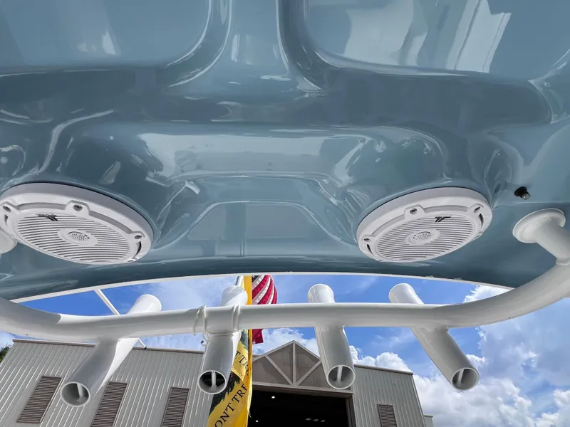 Slide: The Image of 2024 Sea Hunt Ultra 239 SE boat speakers and rod holders against a blue sky. - 49