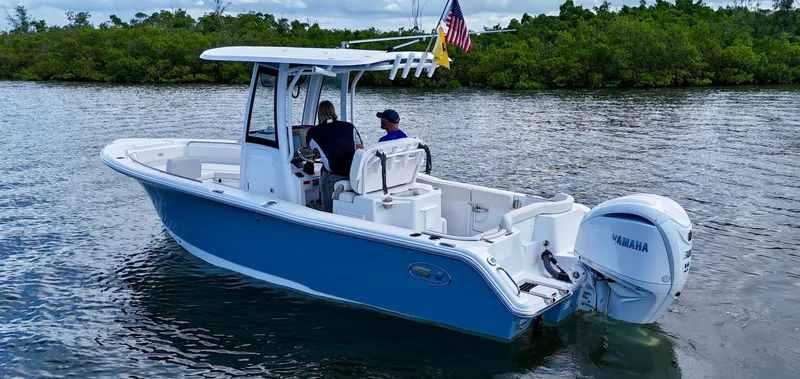 Slide: The Image of 2024 Sea Hunt Ultra 239 SE boat on water, featuring Yamaha engine and American flag. - 6