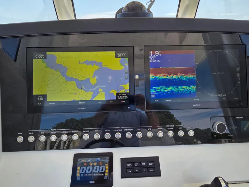 Slide: The Image of Dashboard of 2021 Regulator 31 CC with Garmin navigation displays. - 10