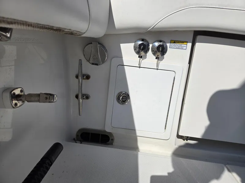 Slide: The Image of 2021 Regulator 31 CC boat interior with storage compartment and metal fixtures. - 12