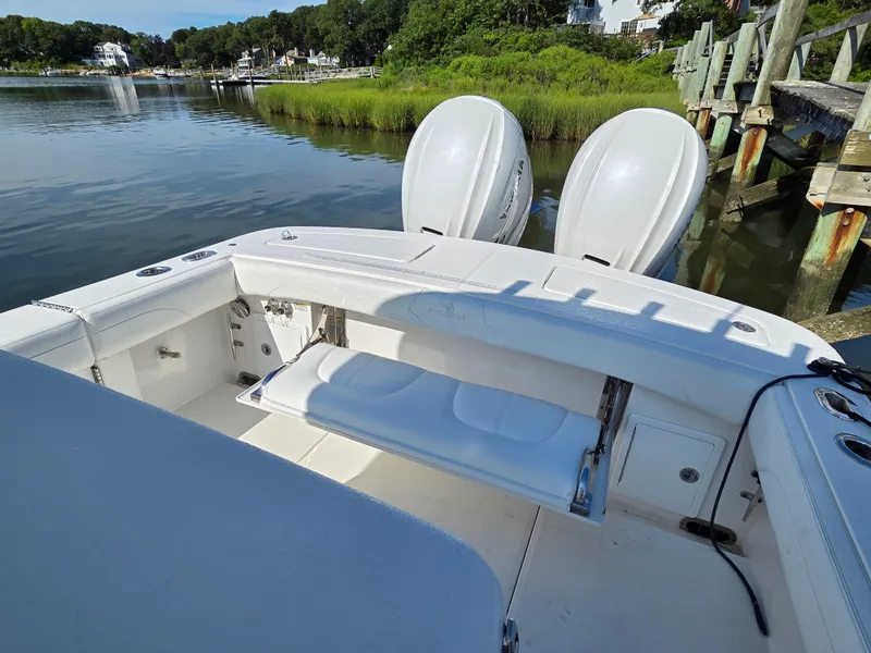 Slide: The Image of 2021 Regulator 31 CC boat with dual engines docked by a scenic waterfront. - 16
