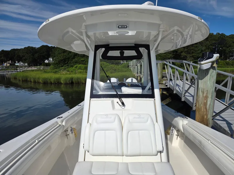 Slide: The Image of 2021 Regulator 31 CC boat docked by a scenic waterfront. - 18