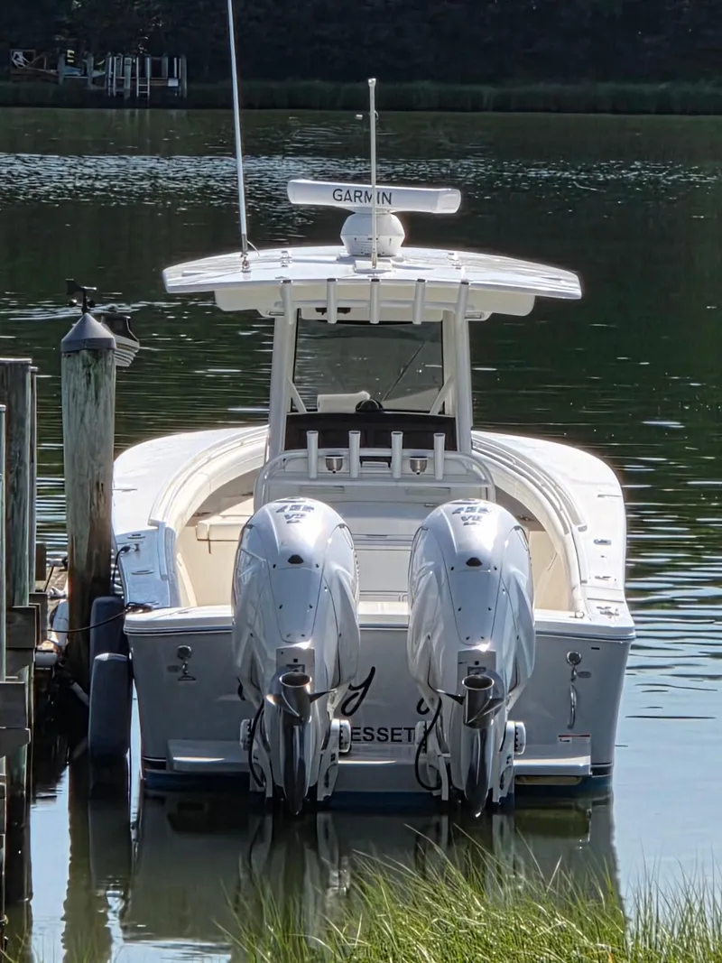 Slide: The Image of 2021 Regulator 31 CC boat docked with twin engines, featuring Garmin equipment. - 4