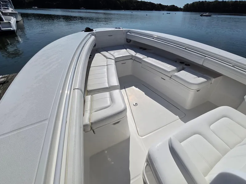 Slide: The Image of 2021 Regulator 31 CC boat with spacious white seating on calm water. - 5
