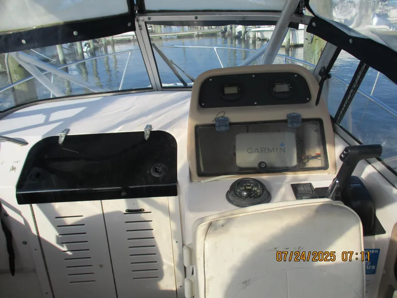 Slide: The Image of 1998 Grady-White 226 Seafarer WA boat cockpit with Garmin navigation system. - 1