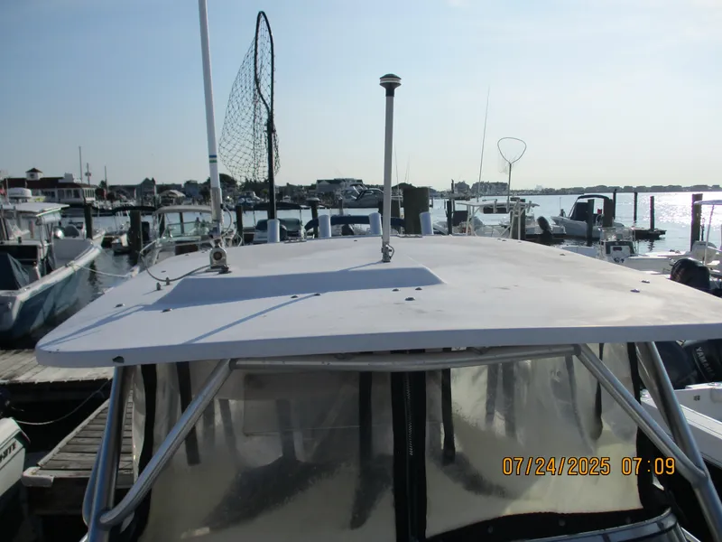 Slide: The Image of 1998 Grady-White 226 Seafarer WA boat docked at marina, sunny day. - 2