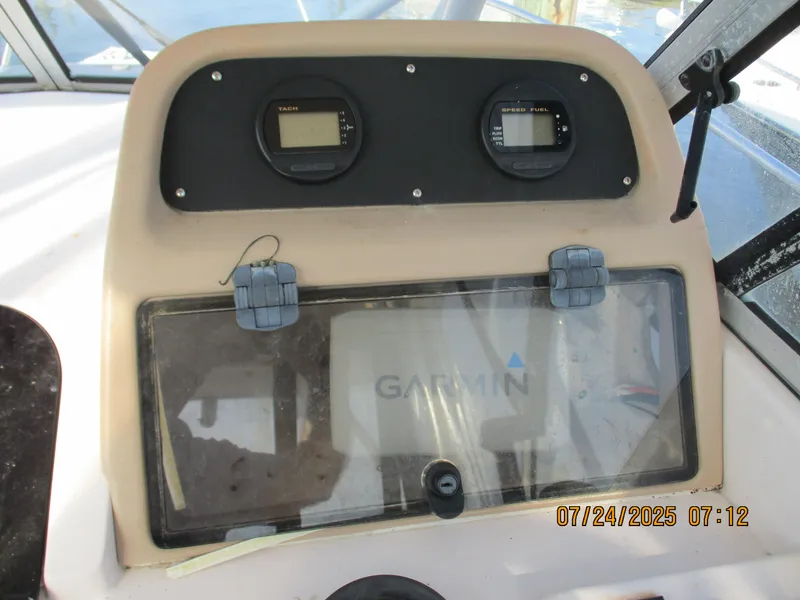 Slide: The Image of 1998 Grady-White 226 Seafarer WA dashboard with Garmin display and dual gauges. - 6