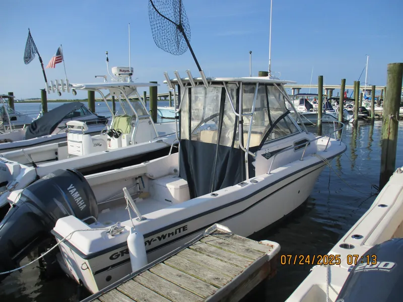 Slide: The Image of 1998 Grady-White 226 Seafarer WA boat docked at marina with Yamaha engine. - 7
