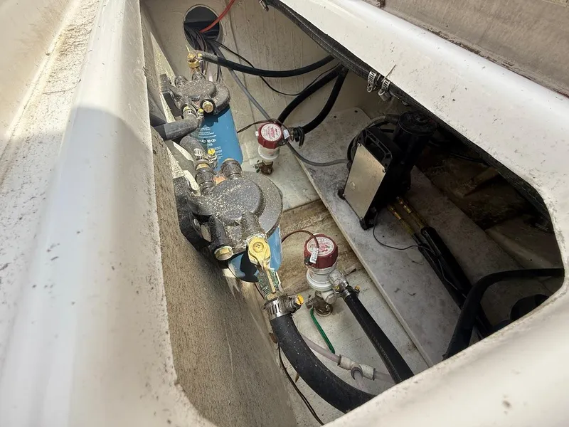 Slide: The Image of 2023 NauticStar 28 XS boat compartment with fuel system components and wiring. - 12