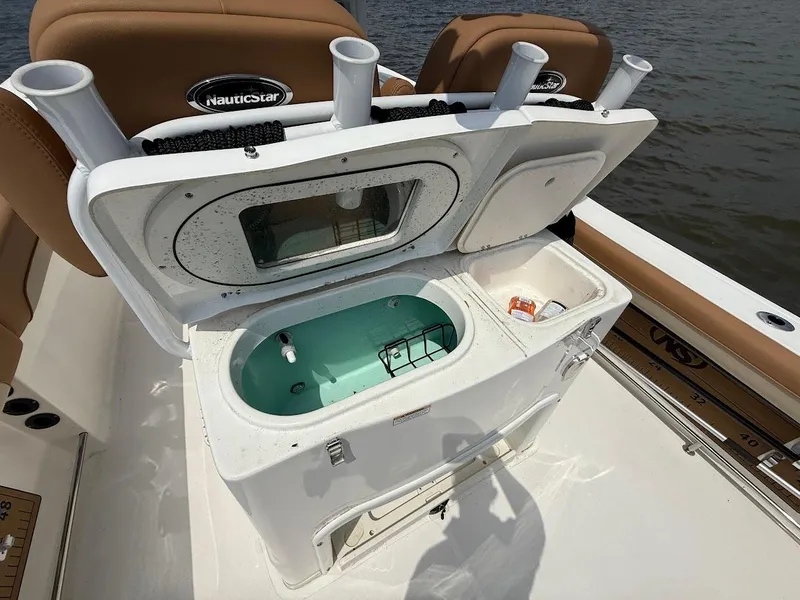 Slide: The Image of 2023 NauticStar 28 XS boat with open livewell and rod holders on deck. - 15