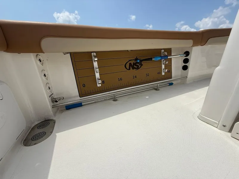 Slide: The Image of 2023 NauticStar 28 XS boat deck with measuring board and rod holders. - 16