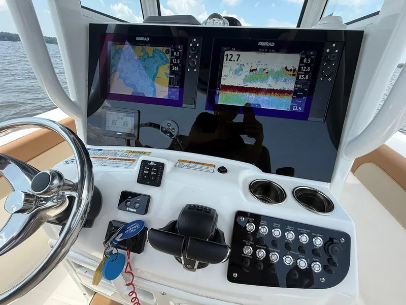 Slide: The Image of Helm of 2023 NauticStar 28 XS with dual Simrad displays and controls. - 20