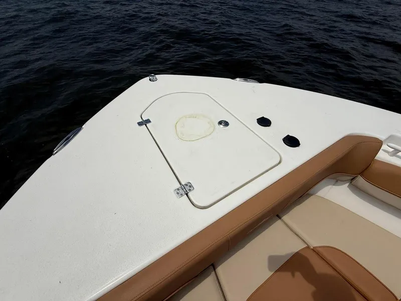 Slide: The Image of 2023 NauticStar 28 XS boat deck with tan seating and storage hatch. - 27