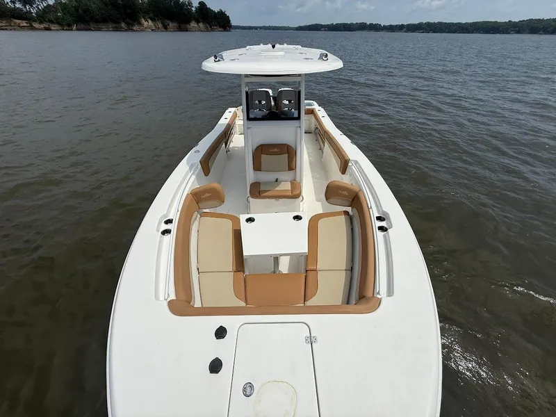 Slide: The Image of 2023 NauticStar 28 XS boat on calm water, featuring spacious seating and sleek design. - 29