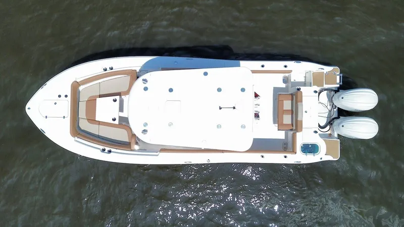 Slide: The Image of 2023 NauticStar 28 XS boat, aerial view, dual engines, sleek design, on water. - 7