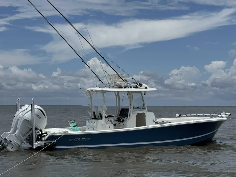 The Image of 2023 Regulator 30XO boat on water, featuring dual outboard engines and fishing rods. - 0