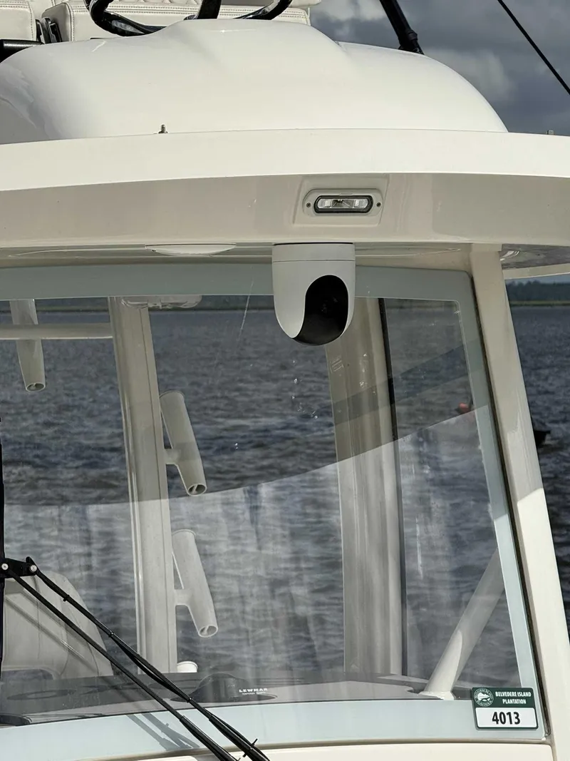 Slide: The Image of 2023 Regulator 30XO boat windshield with wipers and camera, on a calm water background. - 12