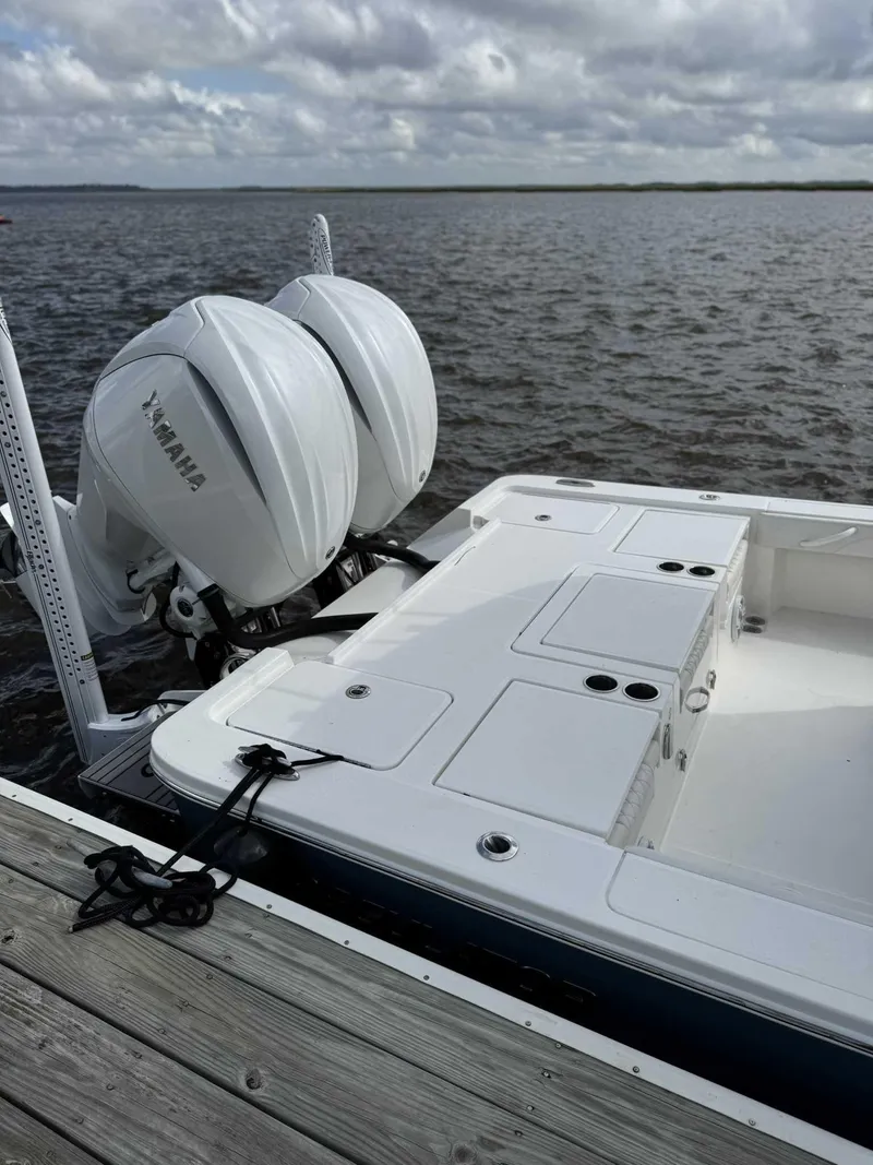 Slide: The Image of 2023 Regulator 30XO boat with Yamaha engines docked by the water. - 6