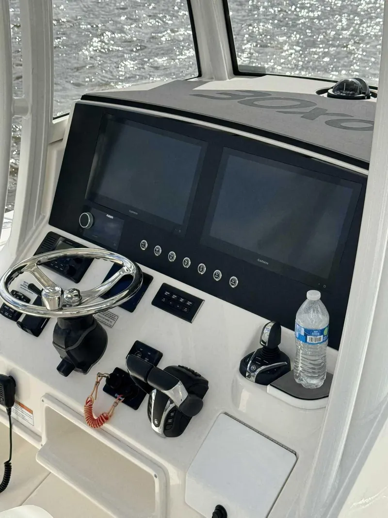 Slide: The Image of 2023 Regulator 30XO boat dashboard with dual screens and steering wheel. - 8
