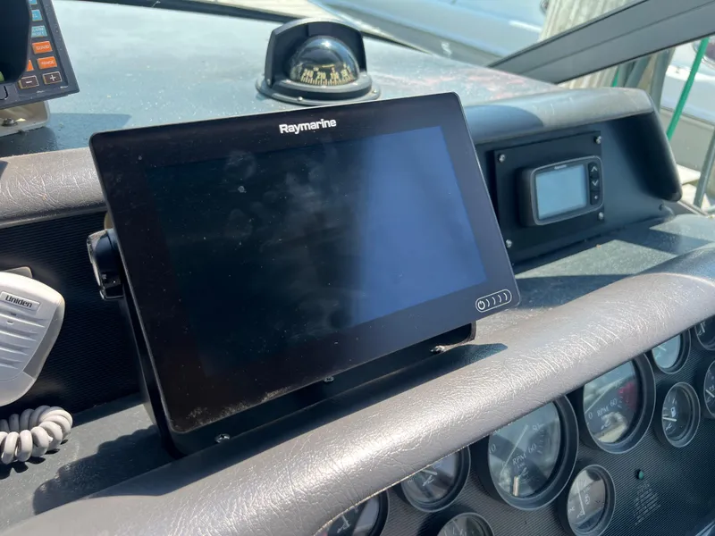 Slide: The Image of Control panel of a 1991 Sea Ray 310 Sundancer with Raymarine display and compass. - 15