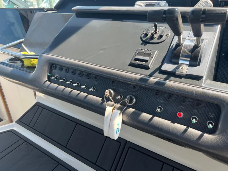 Slide: The Image of Control panel of a 1991 Sea Ray 310 Sundancer boat with switches and levers. - 16