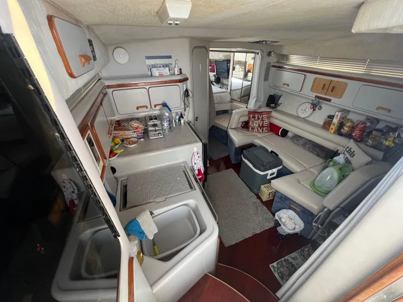 Slide: The Image of Interior of 1991 Sea Ray 310 Sundancer with kitchen and seating area. - 17