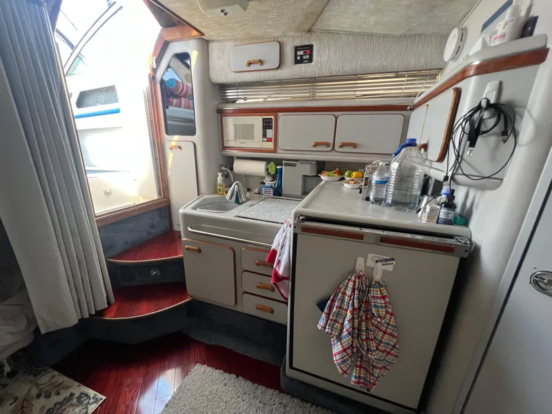 Slide: The Image of Interior of 1991 Sea Ray 310 Sundancer boat with kitchenette and steps. - 18