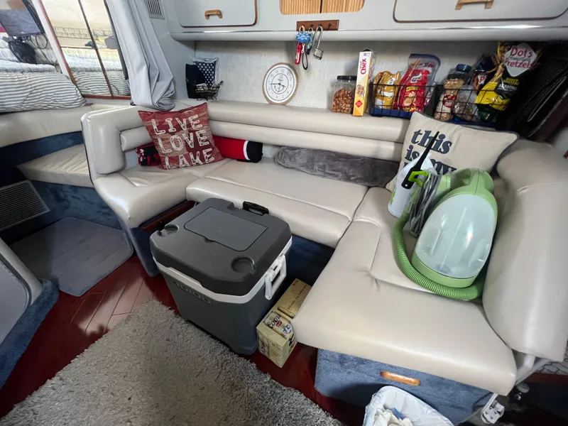 Slide: The Image of Interior of 1991 Sea Ray 310 Sundancer with cozy seating and snacks. - 20