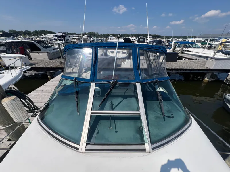 Slide: The Image of 1991 Sea Ray 310 Sundancer docked at marina under clear blue sky. - 7