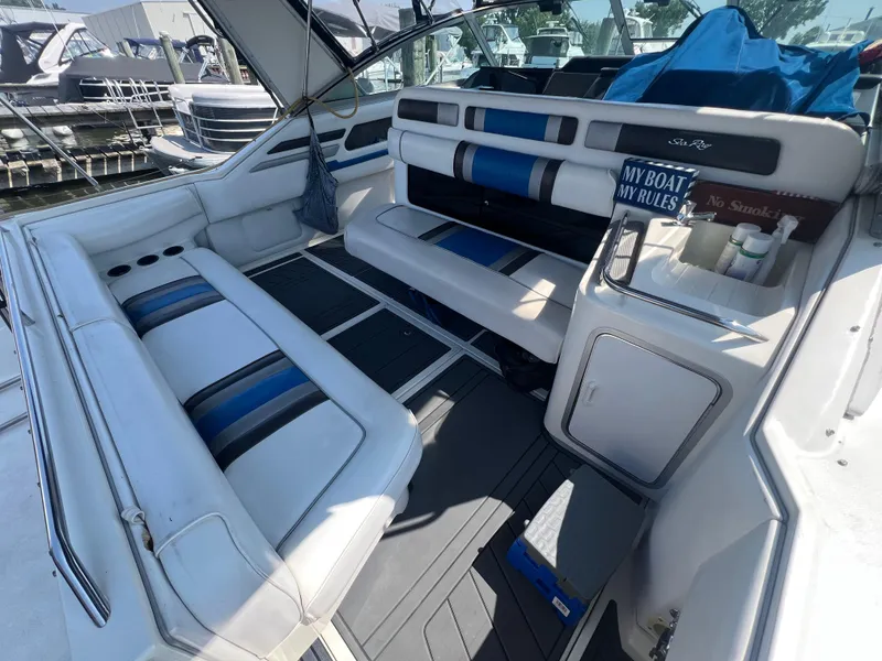 Slide: The Image of 1991 Sea Ray 310 Sundancer boat interior with seating and storage compartments. - 9
