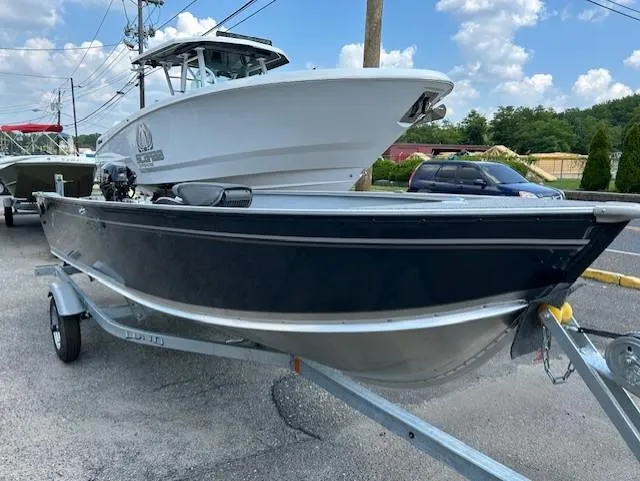 The Image of 2026 Lund 1600 Fury Tiller boat on trailer, parked outdoors under a blue sky. - 0