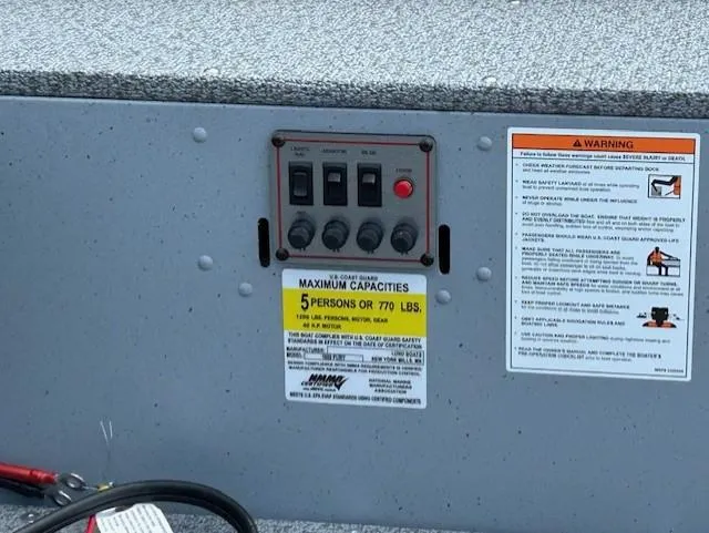 Slide: The Image of Control panel and capacity warning on 2026 Lund 1600 Fury Tiller boat. - 10