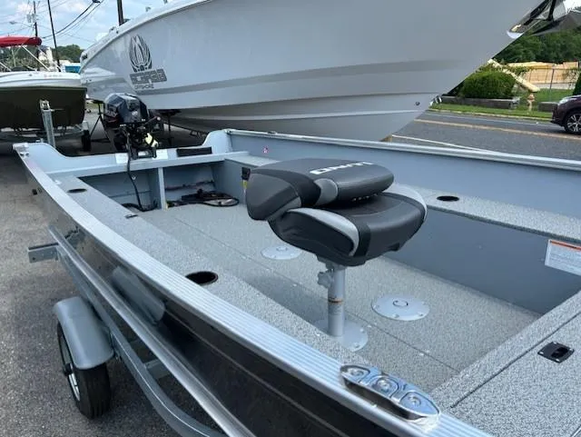 Slide: The Image of 2026 Lund 1600 Fury Tiller boat with seating, displayed outdoors on a trailer. - 3