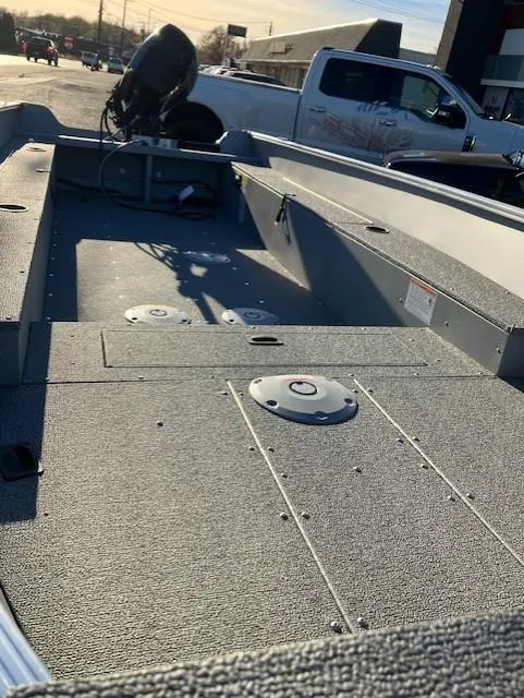 Slide: The Image of 2025 Lund 1600 Fury Tiller boat, spacious interior, parked outdoors. - 5