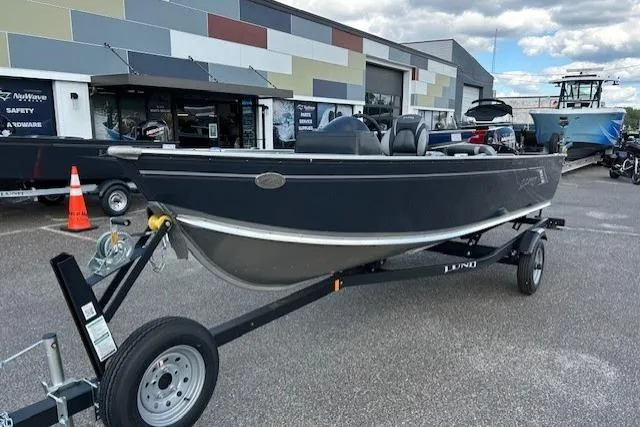 Slide: The Image of 2026 Lund 1600 Fury SS boat on trailer, parked outside dealership. - 2