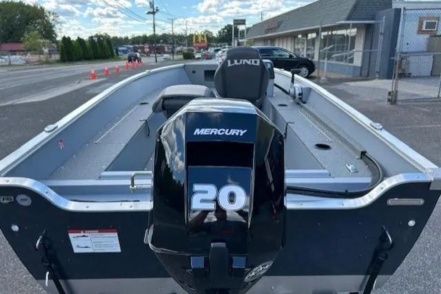Slide: The Image of 2026 Lund 1600 Fury SS boat with Mercury 20 engine, parked outdoors. - 3
