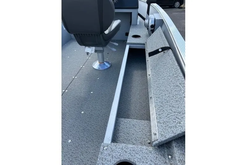 Slide: The Image of 2026 Lund 1600 Fury SS boat interior with seating and storage compartments. - 6