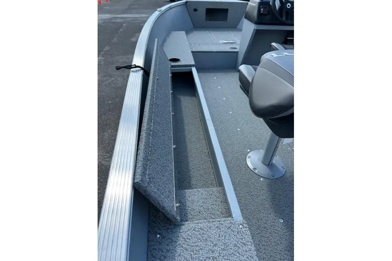 Slide: The Image of 2026 Lund 1600 Fury SS boat interior with seating and storage compartments. - 7