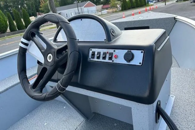 Slide: The Image of Steering console of 2026 Lund 1600 Fury SS boat with control panel. - 8