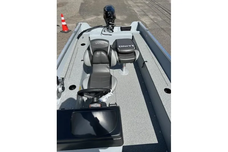 Slide: The Image of 2026 Lund 1600 Fury SS boat interior with gray seating and steering console. - 9