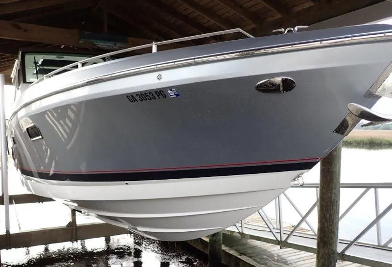 Slide: The Image of 2020 Formula 430 Super Sport Crossover boat docked under a wooden shelter. - 17