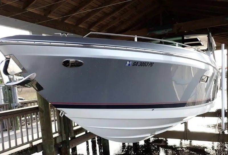 Slide: The Image of 2020 Formula 430 Super Sport Crossover boat docked under a wooden shelter. - 18