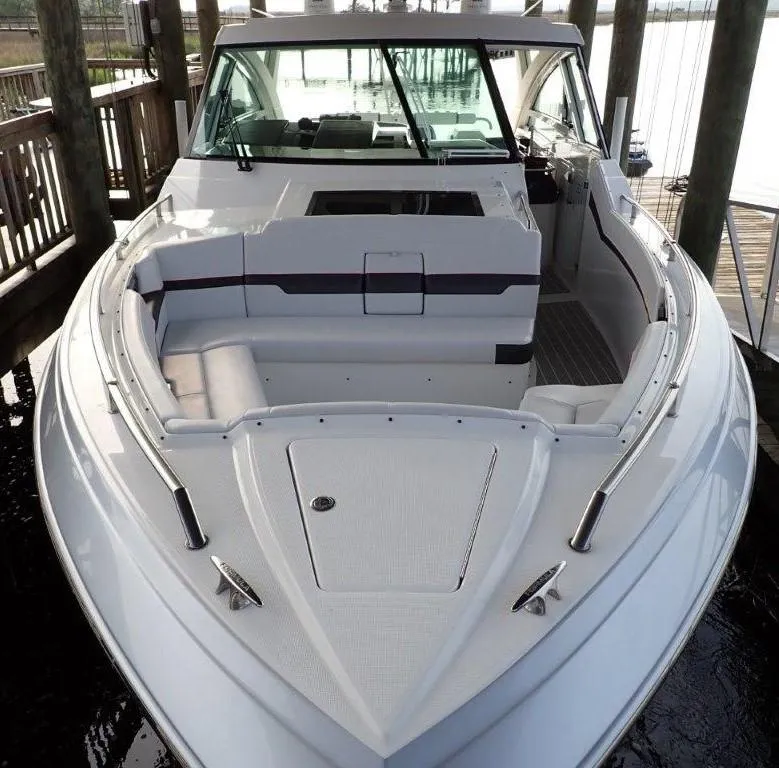 Slide: The Image of 2020 Formula 430 Super Sport Crossover boat docked, showcasing sleek design and spacious seating. - 19