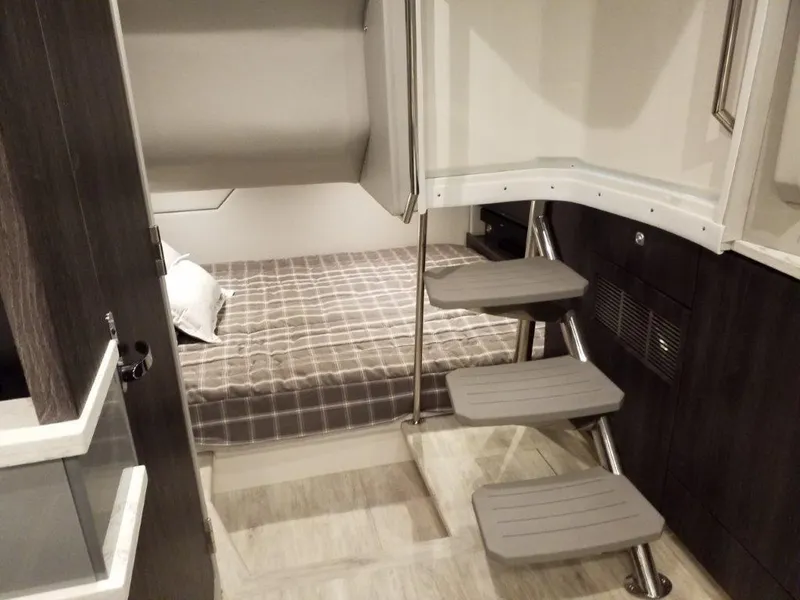 Slide: The Image of Interior of 2020 Formula 430 Super Sport Crossover, featuring a cozy cabin with a bed and stairs. - 40