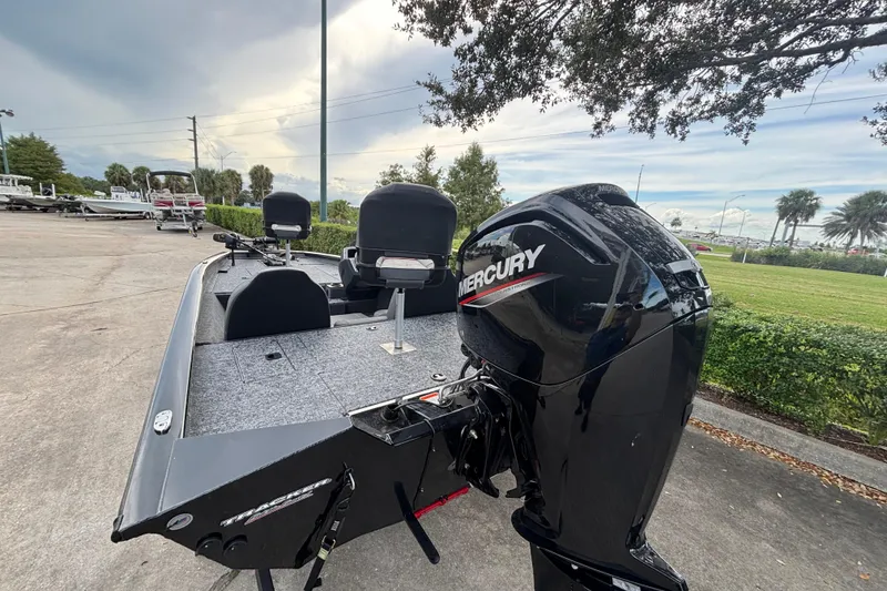 Slide: The Image of 2025 Tracker Pro Team 175 boat with Mercury engine, parked outdoors. - 3