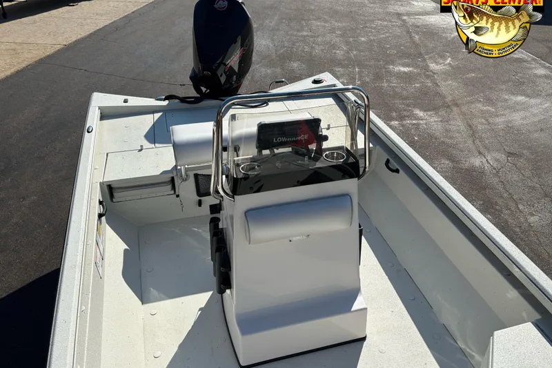 Slide: The Image of 2025 Ranger RB210 boat interior with console and motor, parked on pavement. - 6