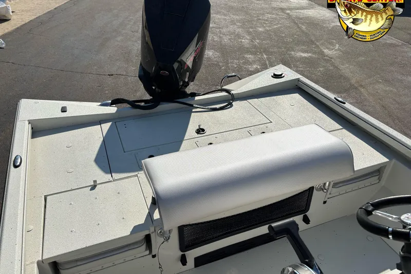 Slide: The Image of 2025 Ranger RB210 boat interior with motor, white seating, and storage compartments. - 7