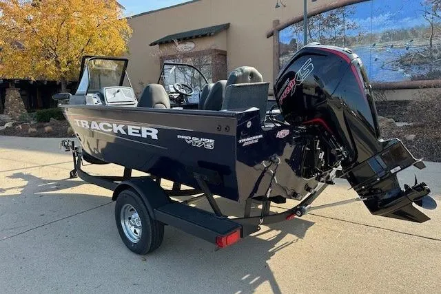 Slide: The Image of 2025 Tracker Pro Guide V-175 Combo boat on trailer, outdoor setting. - 2